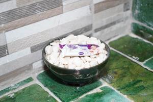 a bowl filled with rocks on a tiled floor at Riad Zagora Palms in Zagora