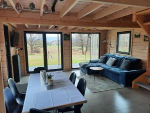 a living room with a blue couch and a table at Domki Łomnicka Ostoja in Łomnica