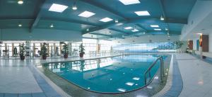 a large swimming pool in a large building at Citic Ningbo International Hotel in Ningbo