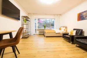 a living room with a bed and a couch at Homefeeling Apartment am Eisweiher Park in Pirmasens +14 photos