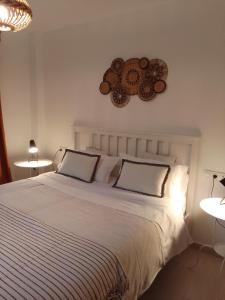 a bedroom with a large white bed with two pillows at La Calma in Lliber