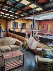 a living room with a hammock in a house at Vihara - Spa, Yoga, Wellness & Events in Antigua Guatemala