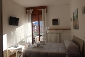 a bedroom with a bed and a window with a view at Bed & Breakfast Il Sentiero in Agerola