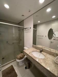 a bathroom with a toilet and a sink and a shower at Manaus hotéis millennium flat in Manaus