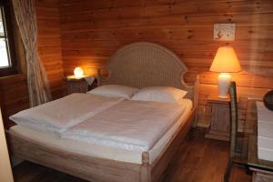 a bedroom with a bed in a wooden room at gemütliches Tiroler Blockhaus in Aschau