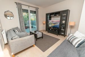 a living room with a couch and a tv at AirZen in (( Kermetés ))