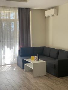 a living room with a blue couch and a coffee table at Green park Sandanski in Sandanski +20 photos