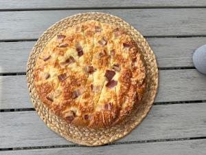 a pizza sitting on top of a wooden table at BREZA mobile house BIG BERRY in Metlika +42 photos