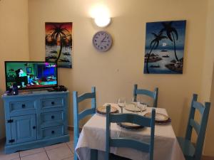 a dining room with a table and a clock on the wall at Residence Amanda with pool in Santa Maria