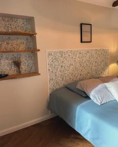 a bedroom with a bed and a shelf at La Saint-Pauloise in Saint-Paul-de-Vence
