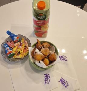 a table with a bowl of food and a bottle of candy at Old Town Apartment in Omiš