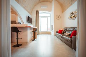 a living room with a couch and a table at Bianca Relax & SPA - Housea in Polignano a Mare
