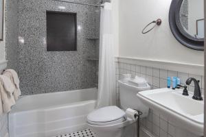 a white bathroom with a toilet and a sink at The Ridgeway Inn in Blowing Rock