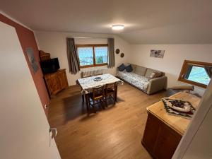 a living room with a table and a couch at Residenza Sertorelli in Bormio