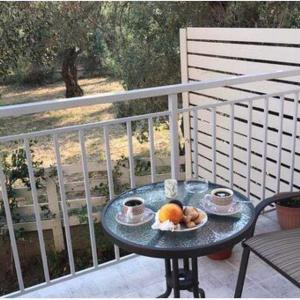 a table with a plate of fruit on a balcony at ERA Studios in Skiathos