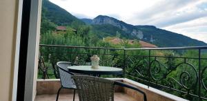 a table and chairs on a balcony with a view at Olympus House in Litochoro
