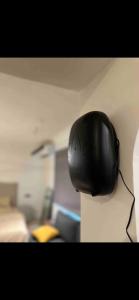 a black computer mouse hanging on a wall at استديو بتصميم عصري ومريح في موقع مميز in Riyadh