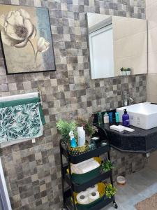 a bathroom with a sink and a mirror at Appartement de luxe avec un toit terrasse in Nouakchott