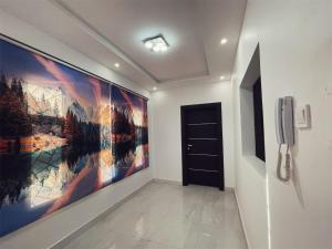 a hallway with a large painting on the wall at Appartement de luxe avec un toit terrasse in Nouakchott