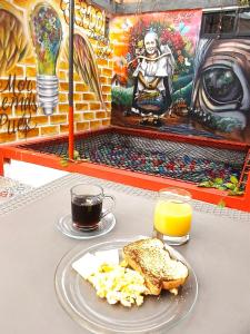 a table with a plate of food and orange juice at PRADO DOWNTOWN in Medellín