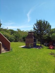a brick building in the middle of a grass field at Habitación frente al mar in Mar del Plata