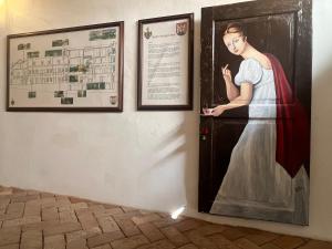 a painting of a woman standing at a door at Spillenberg House Main Property 2024 in Levoča