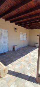 a patio with two white doors and a stone floor at Casa el Benteveo in San Luis