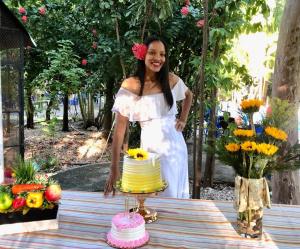 a woman in a white dress standing next to a cake at Hotel y Villa Marchena in Azua de Compostela