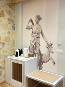 a statue of a woman and a goat in a museum at Dimitri Hotel in Himare