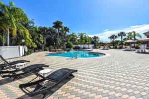 a swimming pool with two lounge chairs next to it at Holiday Inn Express & Suites Cocoa, an IHG Hotel in Cocoa