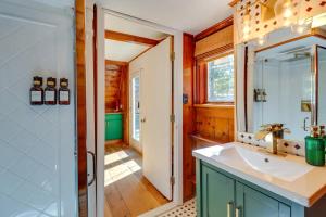 a bathroom with a sink and a mirror at Pocono Getaway A frame Cabin w/ Hot Tub Sauna in East Stroudsburg