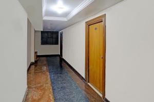 a hallway with a wooden door in a room at SPOT ON Hotel Rk Residency Near MGBS Bus station in Hyderabad