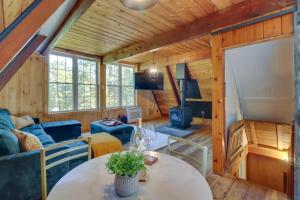 a living room with a couch and a table in a cabin at Pocono Getaway A frame Cabin w/ Hot Tub Sauna in East Stroudsburg