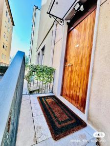 a wooden door with a rug in front of a building at City life Arsenale in Verona