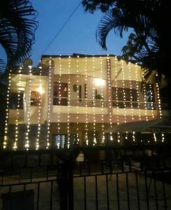 a lit up building with christmas lights on it at Nest in Nashik