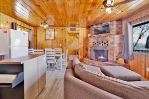 a living room with a couch and a fireplace at Sunrise Lakefront Family Cabin by Big Bear Vacations in Big Bear Lake