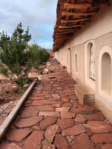 a stone walk way next to a building em Ecolodge Espace Tamount em Demnat