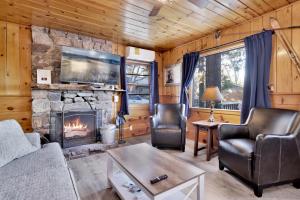 a living room with a fireplace in a cabin at Lakeside Family Cabin by Big Bear Vacations in Big Bear Lake