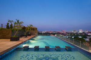 a swimming pool on the roof of a building at Best Western De Papilio in Surabaya