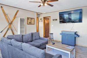 a living room with a couch and a table at Lakefront Family Cabin by Big Bear Vacations in Big Bear Lake