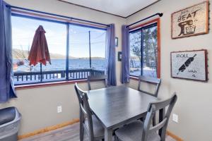 a dining room with a table and chairs and a window at Lakefront Family Cabin by Big Bear Vacations in Big Bear Lake