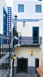 a white building with blue and white stairs at CASONA ALBARELO in Puebla