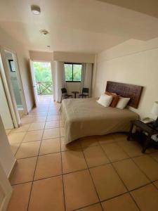 1 dormitorio con 1 cama en el suelo de baldosa en Tower Suite Hotel Coronado, en Playa Coronado