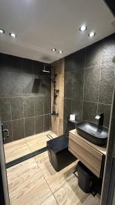 a bathroom with a black sink and a shower at The Lodge Ajloun in Ajloun