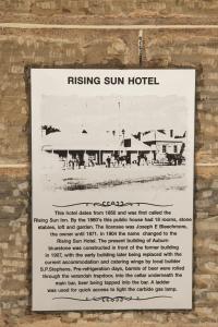 a sign for a rising sun hotel on a wall at The Rising Sun Hotel in Auburn