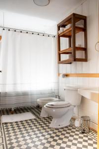 a bathroom with a toilet and a sink at La Casa de Alerce in Chacao +34 photos