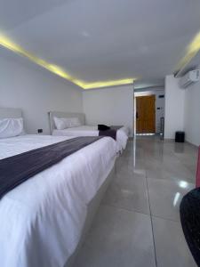 two beds in a hotel room with at The Lodge Ajloun in Ajloun
