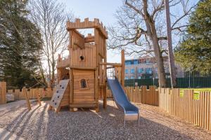 a wooden playset with a slide and a slideintend at Woodward Square in Dublin