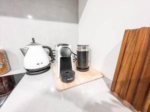 a kitchen counter with a coffee maker and a blender at City Centre - Pool - Parking - Self check-in in Canberra
