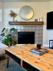 a living room with a table and a fireplace at Sunshine House in Reno